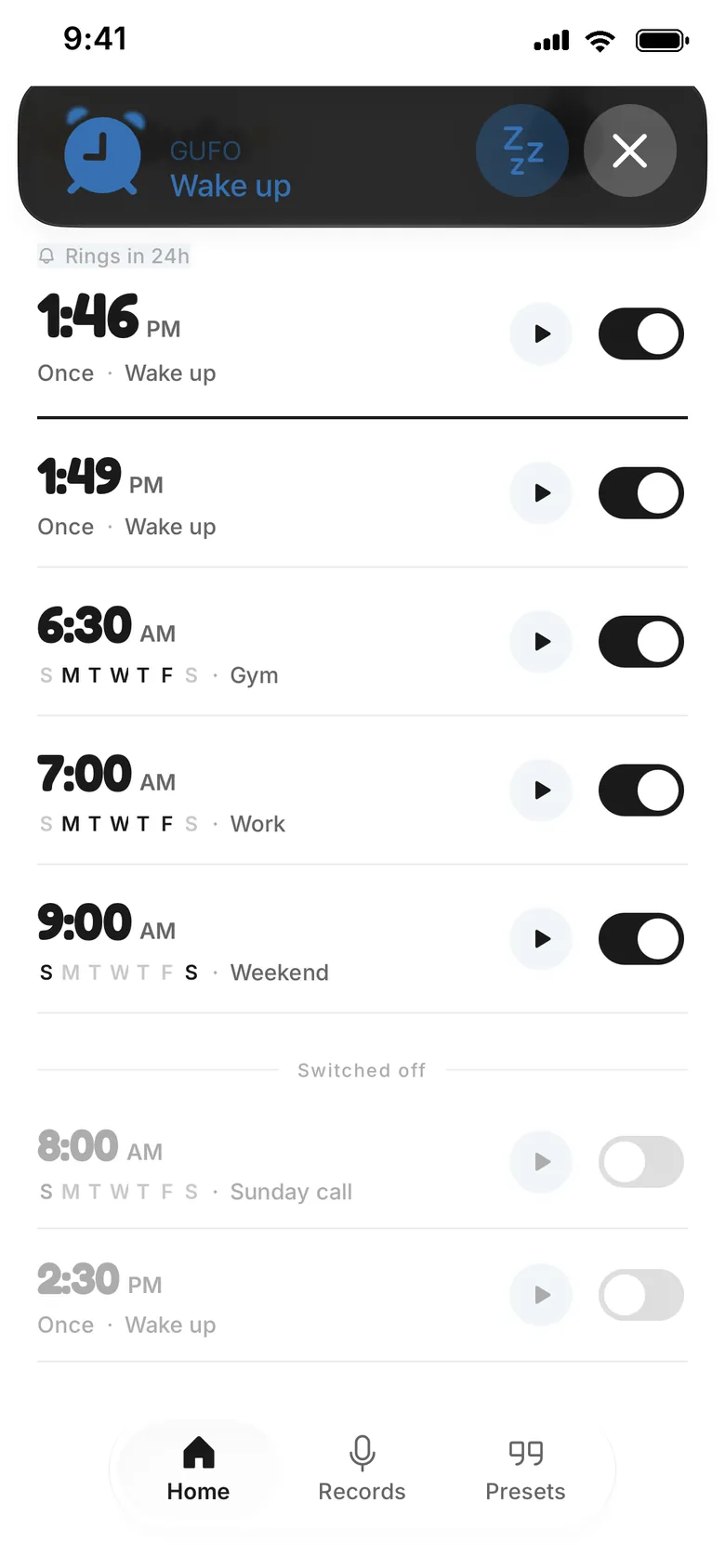 Apple's alarm alert for a GUFO alarm called Wake up, over GUFO's alarm list, with snooze and stop buttons